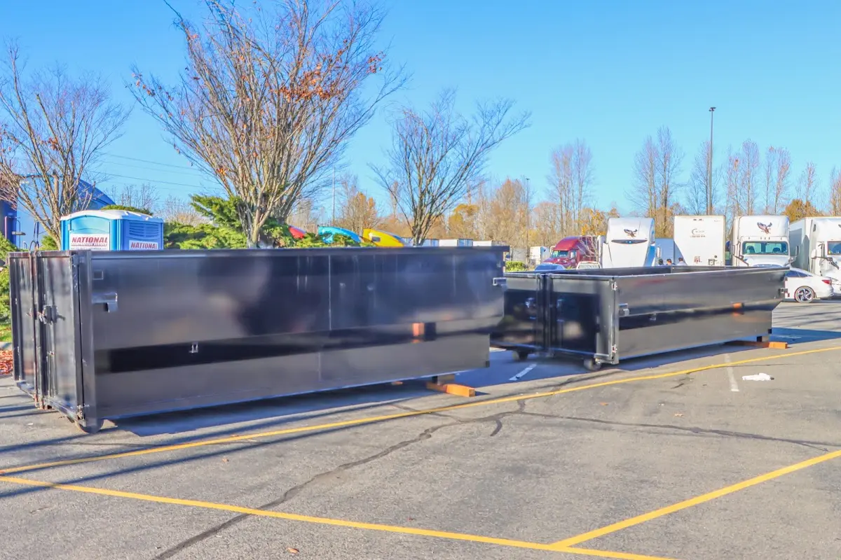 Professional dumpster rental service with roll-off container on residential driveway in North College Hill